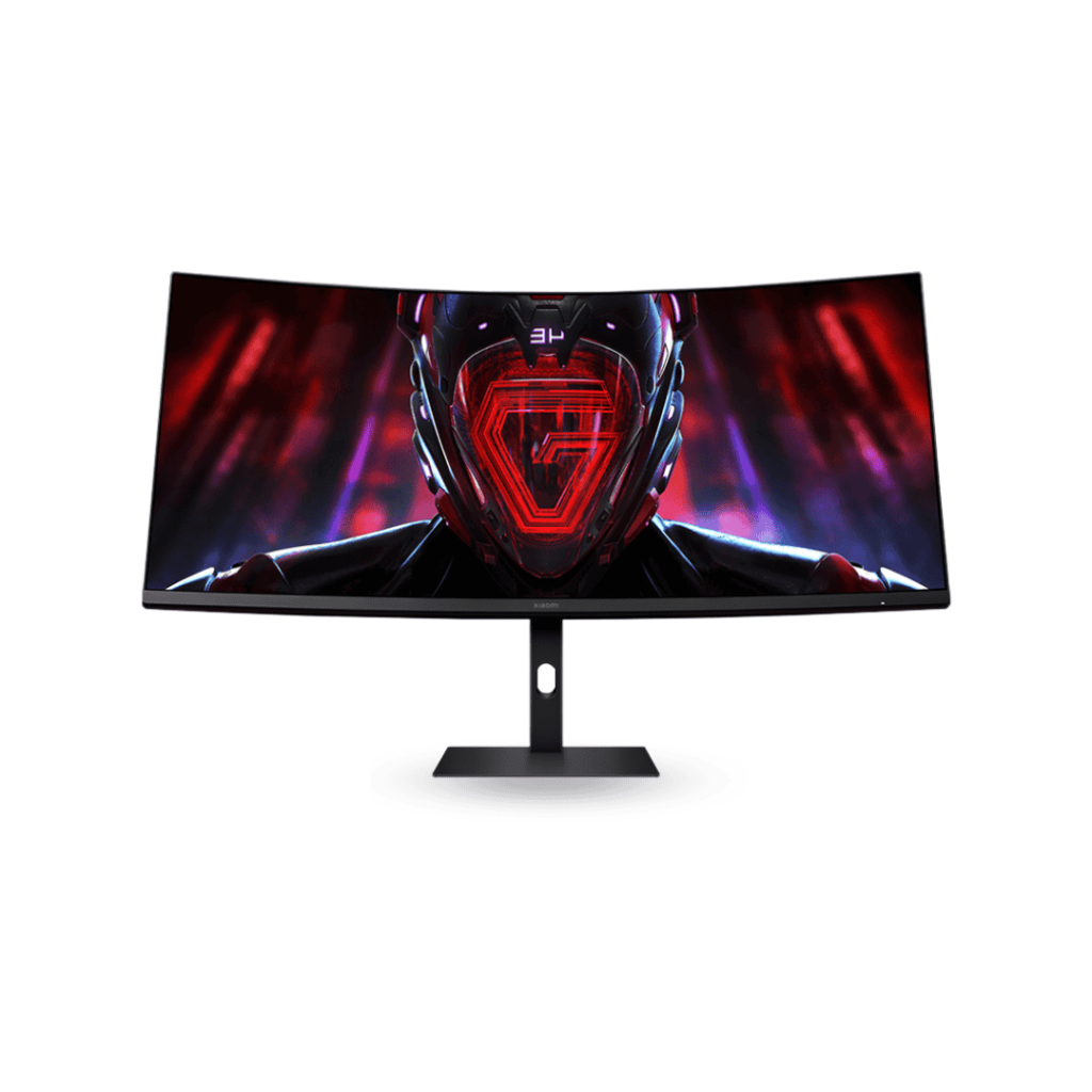 A front-facing view of the Xiaomi Mi Curved Display G34WQi 34-inch gaming monitor. The black, ultrawide curved screen is prominently featured on a minimalist stand, displaying an intense, futuristic graphic of a red and black helmet with glowing lines, indicative of its high-resolution gaming capabilities.