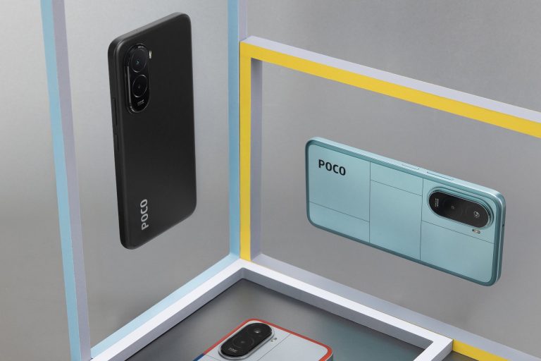 A studio product shot featuring three POCO smartphones in a geometric setup. One phone is black, suspended vertically on a gray background on the left. Another phone is light blue, suspended horizontally on a gray background on the right. The third phone is white with red and blue accents, resting on a white platform at the bottom. The scene is framed by yellow and white rectangular shapes, creating a minimalist, modern display.